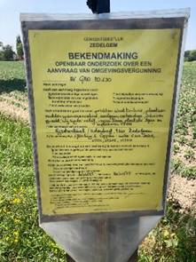 A sign in a field

AI-generated content may be incorrect.